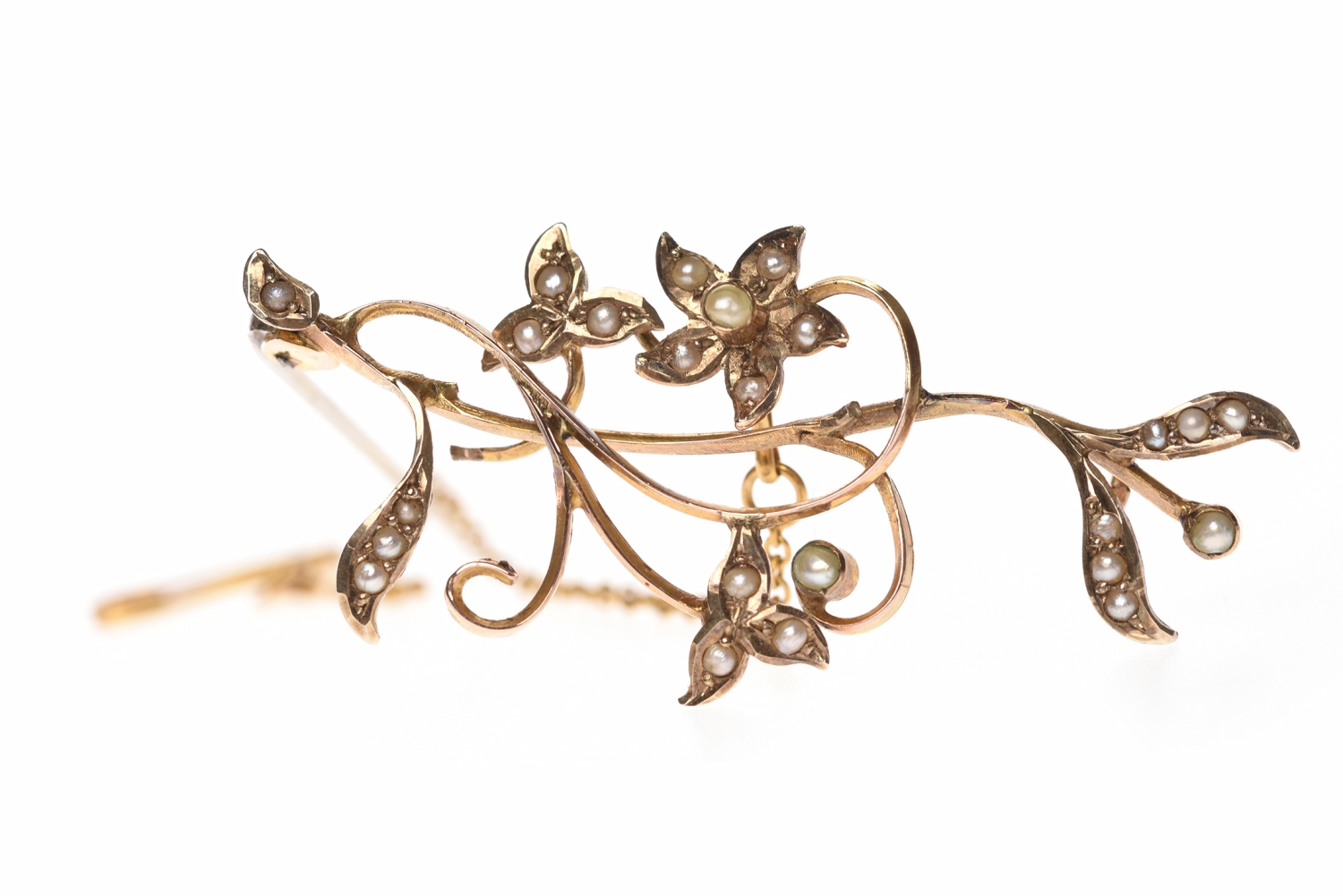 EDWARDIAN NINE CARAT GOLD SEED PEARL BROOCH of openwork floral spray form,