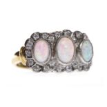 GOLD PLATED OPALINE RING the three collet set raised stones within a gem set border, 11.