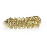 NINE CARAT GOLD YELLOW GEM SET RING set with three rows of round yellow gems, size M, 2.