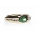 PASTE SET DRESS RING set with a central oval green paste flanked by two rows of channel set round