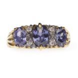 GOLD PLATED GEM SET RING set with oval purple gems, the largest approximately 6.2x4.