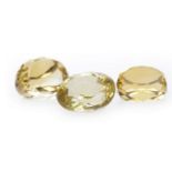 THREE UNMOUNTED CITRINES two cut and faceted to be mounted in fobs, 19mm and 22mm long,