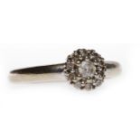 NINE CARAT GOLD DIAMOND CLUSTER RING set with a central round brilliant cut diamond of