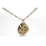 NINE CARAT GOLD NUGGET PENDANT in nine carat gold, on a chain 24.5cm long, 21.