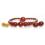 EARLY TWENTIETH CENTURY BAKELITE NECKLACE formed by graduated ovoid beads,