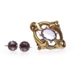 LATE VICTORIAN AMETHYST BROOCH set with a central oval amethyst 15mm long within an openwork