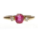 EIGHTEEN CARAT GOLD CREATED RUBY AND DIAMOND THREE STONE RING set with a central oval created ruby