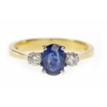 SAPPHIRE AND DIAMOND THREE STONE RING set with a central oval sapphire flanked by two round