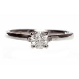 EIGHTEEN CARAT WHITE GOLD DIAMOND SOLITAIRE RING with a four claw set round brilliant cut diamond