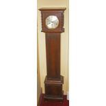 A SMALL INLAID OAK CHIMING GRANDMOTHER CLOCK, with circular dial, and Arabic numerals, the paneled