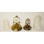 A GERMAN KERN CLOCK, with glass dome, on gilt base; together with a smaller similar ditto, with