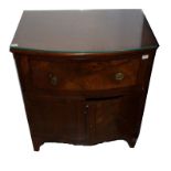 A BOW-FRONTED EBONY STRUNG MAHOGANY BEDSIDE COMMODE, adapted, now with a frieze drawer and two doors