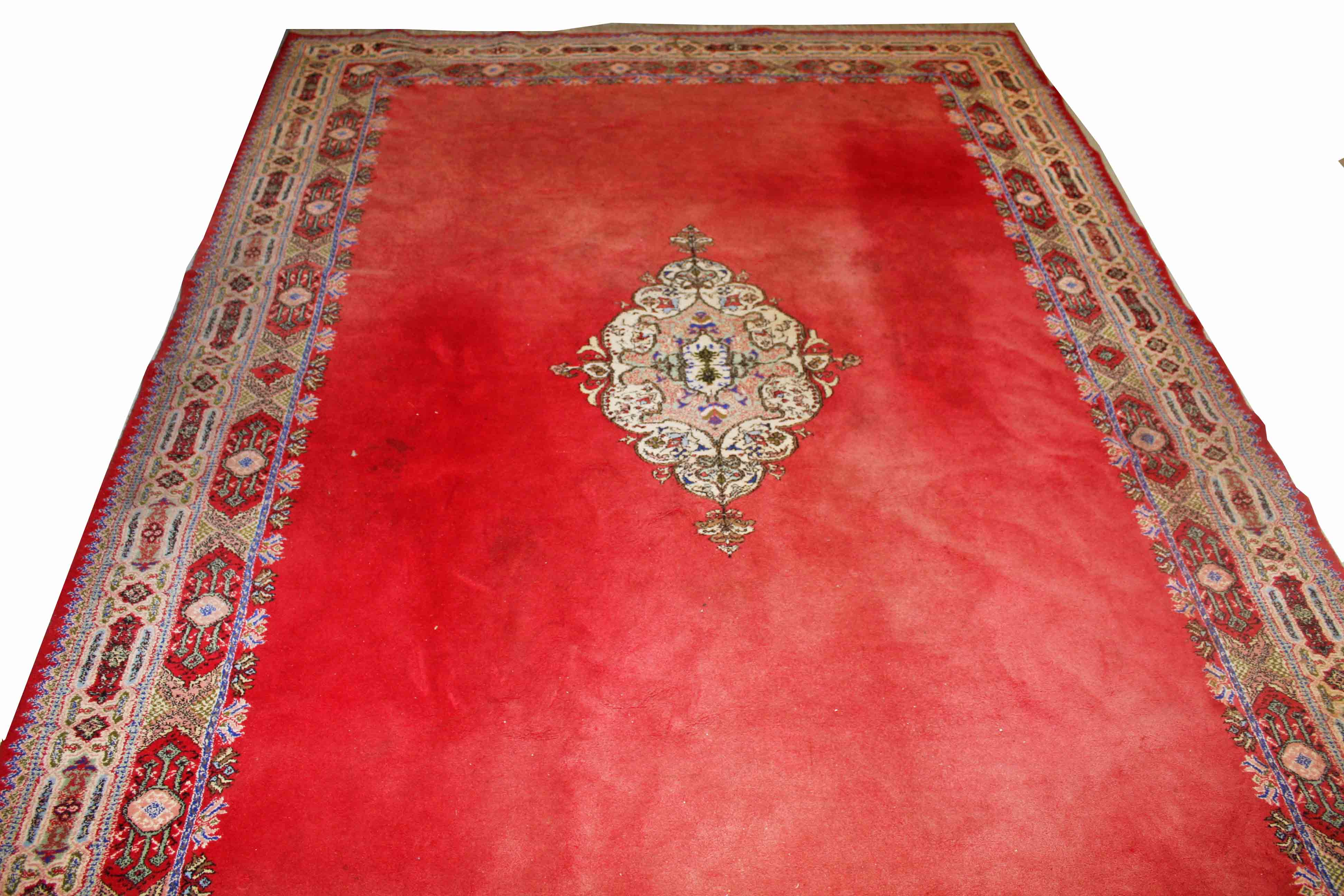 A LARGE MOROCCAN RED GROUND CARPET, with centre medallion, inside a double border, 13ft5 (409cm) x