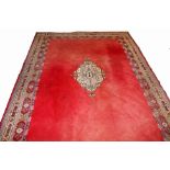 A LARGE MOROCCAN RED GROUND CARPET, with centre medallion, inside a double border, 13ft5 (409cm) x