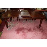 A LATE VICTORIAN TELESCOPIC MAHOGANY DINING TABLE, with two spare leaves, the moulded top raised