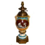 A FRENCH PORCELAIN AND BRASS-MOUNTED OIL LAMP, converted for electricity, the baluster vase shaped