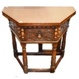 A 17TH CENTURY STYLE CARVED OAK FOLDOVER TEA TABLE, the top with canted corners, above a frieze