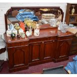 A VICTORIAN MAHOGANY SIDEBOARD, of inverted breakfront outline, with mirror back, above three frieze