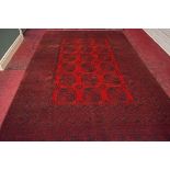 A DARK RED GROUND AFGHAN RUG