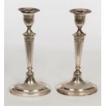 A PAIR OF ADAMS STYLE SILVER CANDLESTICKS