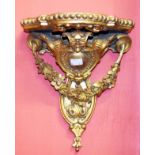 A PAIR OF ROCOCO STYLE GILT AND GESSO WALL BRACKETS