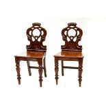 A PAIR OF VICTORIAN MAHOGANY HALL CHAIRS