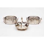 A PAIR OF PIERCED SILVER TWO-HANDLE BUTTER DISHES, Birmingham 1906, each with glass liner and four