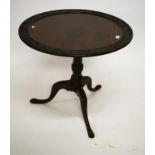 AN UNUSUAL CIRCULAR MAHOGANY FLIP-TOP OCCASIONAL TABLE, the top carved in the Chinoiserie style with