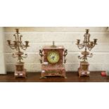 A THREE PIECE FRENCH ROUGE AND VARIEGATED MARBLE MANTEL CLOCK GARNITURE