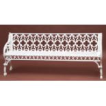 AN EXTREMELY HEAVY CAST IRON GARDEN BENCH, in the Gothic Revival style, the pierced openwork back in