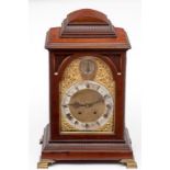 A GEORGIAN STYLE MAHOGANY AND BRASS MOUNTED BRACKET CLOCK, c.1900, the domed and reeded op above