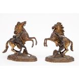 A PAIR OF BRONZE AND GILT BRONZE EQUESTRIAN GROUPS AFTER COUSTOU, 'Marley Horses with Grooms',