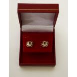 A VERY ATTRACTIVE PAIR OF 9CT GOLD RUBY EAR STUDS, each of octagonal form with oval stones. (1)