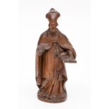 A CARVED WOODEN FIGURE, depicting Saint Theodore, standing holding a book, 14.5" (37cm). (1)