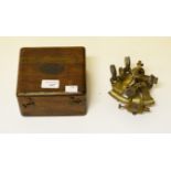 A SMALL CASED BRASS NAUTICAL SEXTANT, O.R.M., in square fitted wooden case, with lenses. (1)