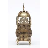 A MODERN BRASS LANTERN CLOCK, with bell shaped domed top, and urn finial, with circular dial with