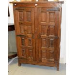 A 17TH CENTURY STYLE OAK SIDE CUPBOARD, with two multi-panel doors, with iron strap-work hinges, the