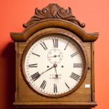 A 19TH CENTURY IRISH PROVINCIAL LONGCASE OAK CLOCK, with cartouche and leaf scroll crest, on an