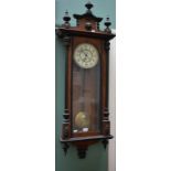 A VICTORIAN WALNUT AND EBONISED VIENNA TYPE WALL CLOCK, the arched pediment with a centre lion