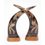 A PAIR OF ETCHED AND DECORATED COW HORNS, from Thailand, each with a dragon and a phoenix on