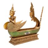 A CARVED GILTWOOD DUG OUT TIE CEREMONIAL BOAT, with buddha figure head, the body inset with coloured