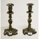 A GOOD PAIR OF HEAVY CAST AND SILVER PLATED CANDLESTICKS, each in the rococo style, with leaf ad