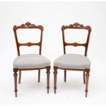 A SET OF SIX LATE VICTORIAN INLAID WALNUT BAR-BACK DINING CHAIRS, each back crested with scrolling