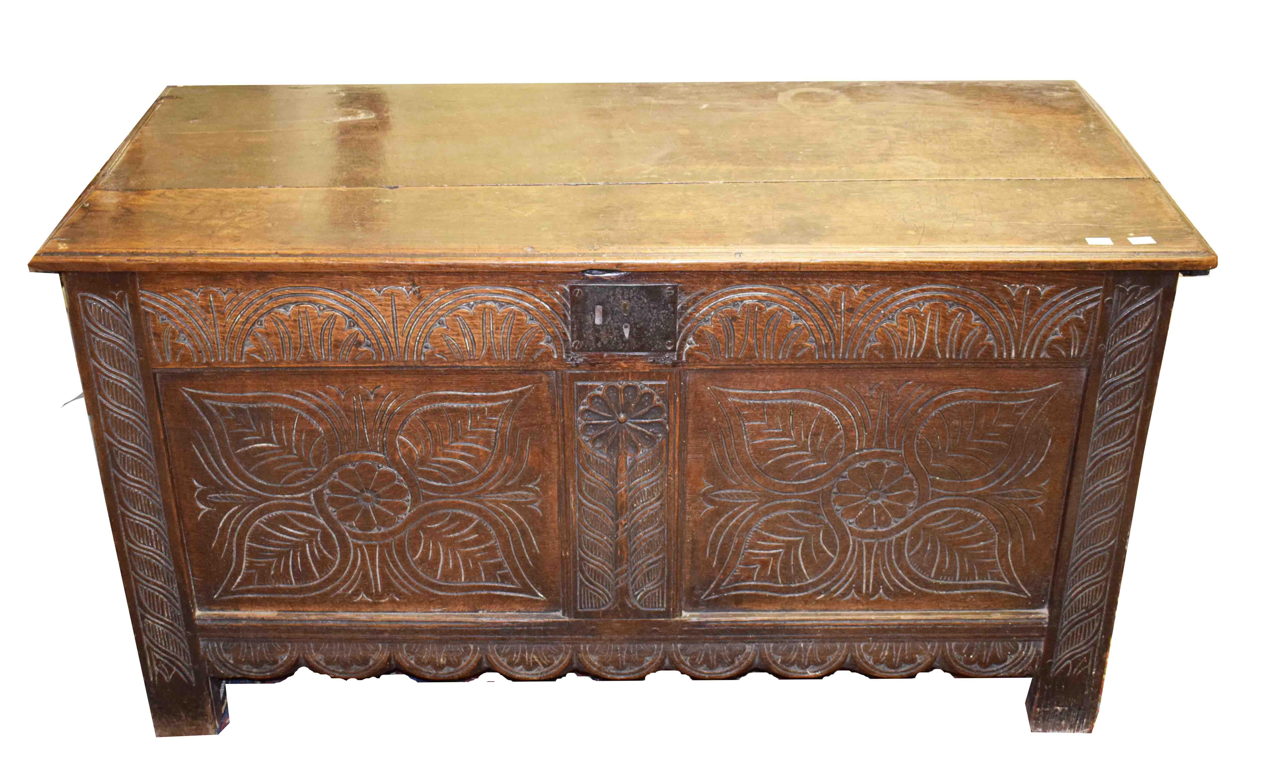 AN 18TH CENTURY OAK PLANK-TOP COFFER CHEST, the rectangular moulded top above a frieze carved with