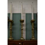 A SET OF SIX ATTRACTIVE LARGE BRASS ALTAR CANDLESTICKS, in the gothic revival style, each with