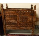 A VERY UNUSUAL 19TH CENTURY INDIAN CARVED WOODEN CUPBOARD, with pierced and carved pediment and