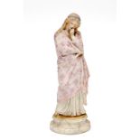 A LATE VICTORIAN GERMAN BISQUE FIGURE, modelled as a pensive lady in floral gown, on circular