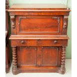 A VICTORIAN MAHOGANY SECRETAIRE, the moulded top above a panelled door, folding back and revealing a