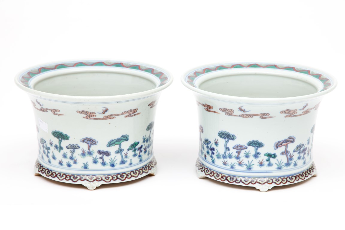 A PAIR OF UNUSUAL CHINESE PORCELAIN PLANTERS, each decorated with flying bats, above clouds and
