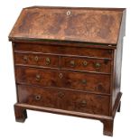 AN EARLY 18TH CENTURY SLOPE-FRONT FIGURED WALNUT BUREAU, with herring-bone cross-banding, the